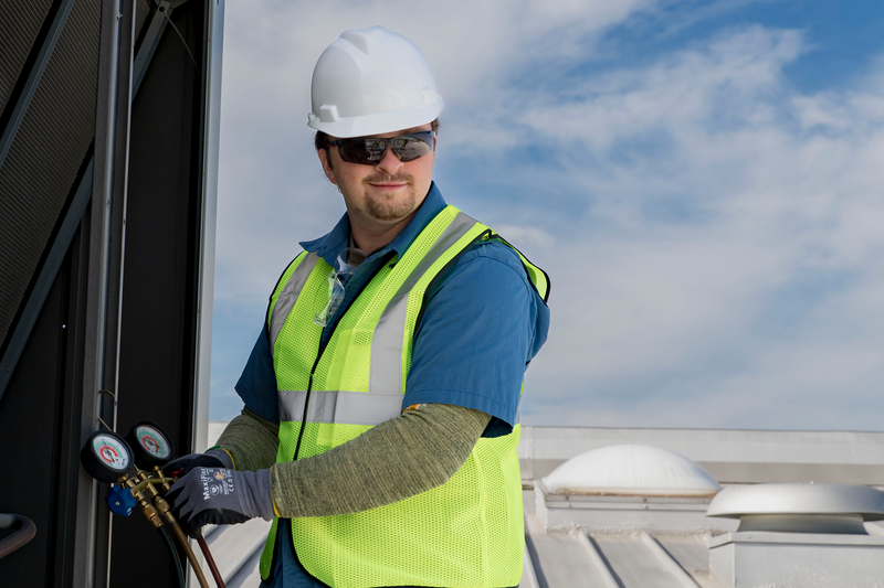 Contractor servicing rooftop HVAC