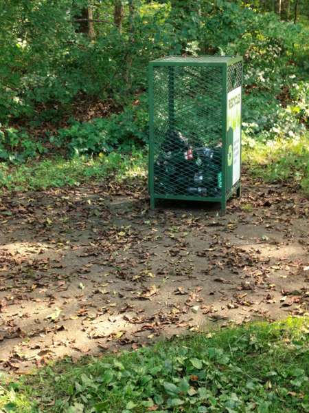 Recycling container in wooded area