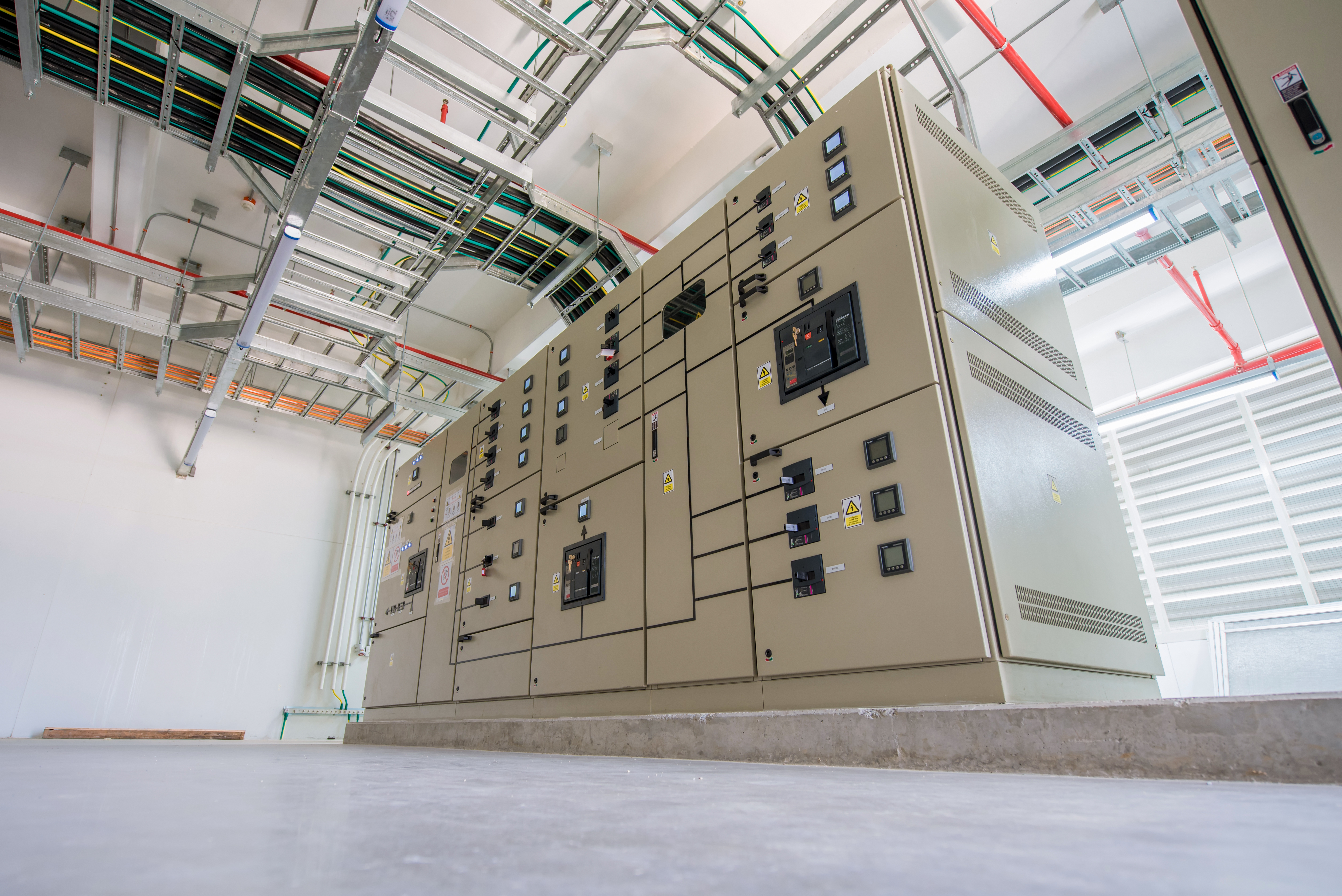 Electrical cabinet enclosed in and made from galvanized and cold rolled steel, within a building.