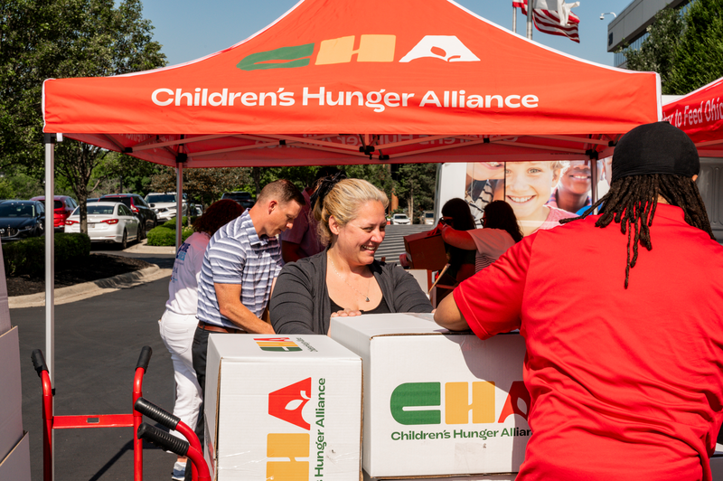 Smiling Employee packing food box